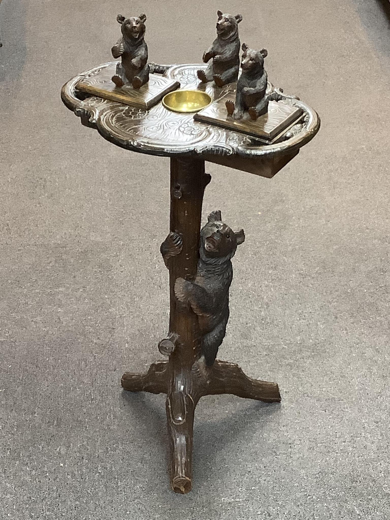 An early 20th century Black Forest musical smoker's stand, height 86cm, with musical movement
